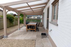 Terras met tuinmeubels onder afdak